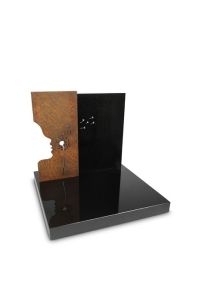 Monumento para urna Dejar Ir con silueta y diente de león, granito y acero Corten